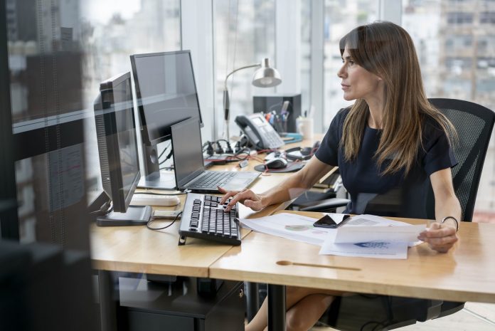 Confident latin american businesswoman working very focused at her office