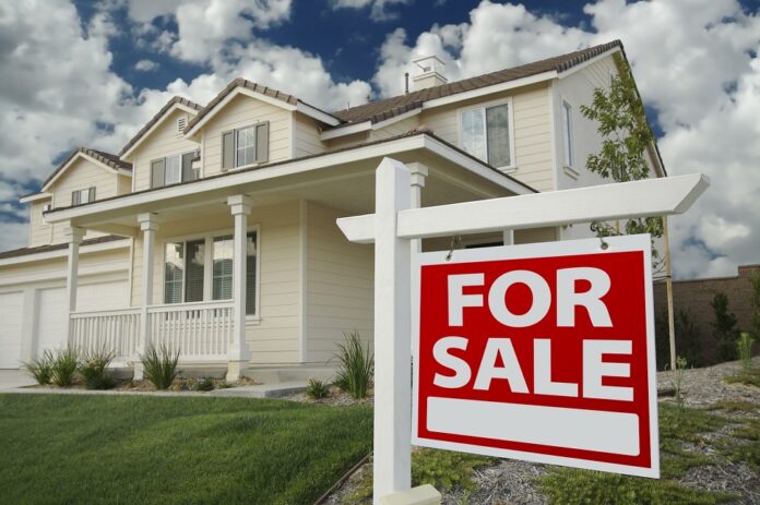 Home For Sale Sign in Front of Beautiful New Home