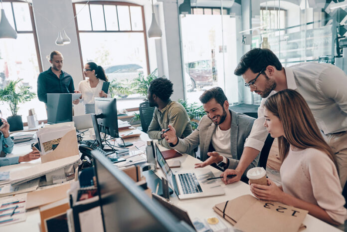 Group,Of,Young,Modern,People,In,Smart,Casual,Wear,Communicating